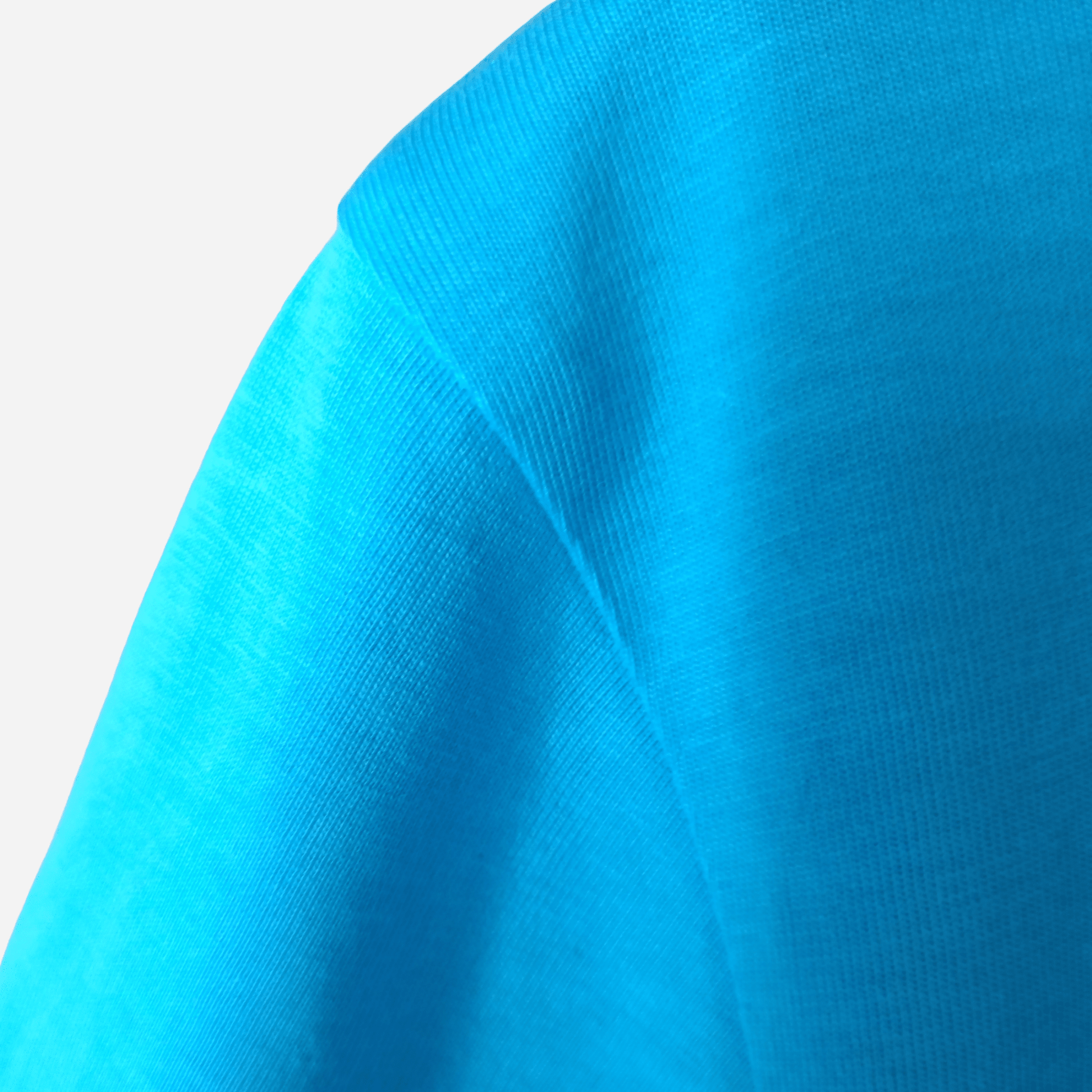 Reinforced shoulder seam stitching on an aqua organic cotton t-shirt, handcrafted by SeaNic for long-lasting coastal wear.