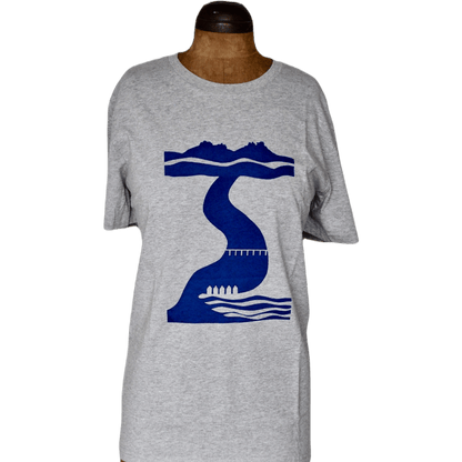 A full-length view of the Tor to Sea organic cotton t-shirt on a wooden mannequin. The image shows the relaxed fit of the grey heather fabric and the central placement of the navy blue Dartmoor-to-coast screen print.